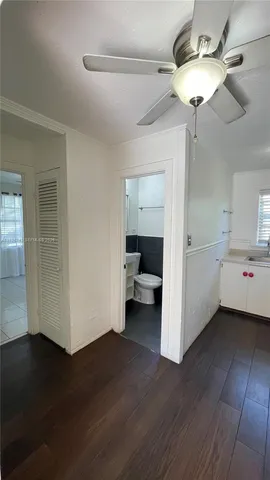 a bathroom with a sink a toilet a mirror and shower