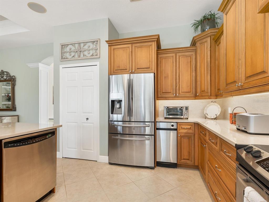 13911 Siena Loop Lakewood Ranch, FL 34202 - Photo 15 of 63 a kitchen with stainless steel appliances granite countertop a refrigerator sink and stove