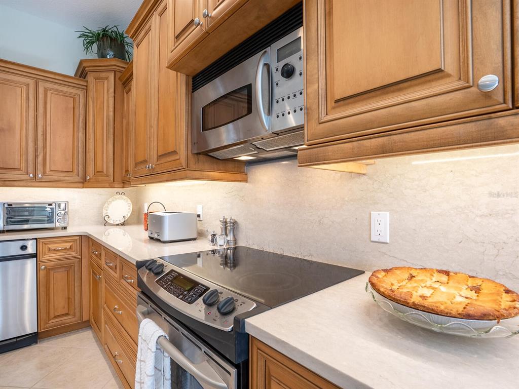 13911 Siena Loop Lakewood Ranch, FL 34202 - Photo 16 of 63 a kitchen with a sink a stove and cabinets