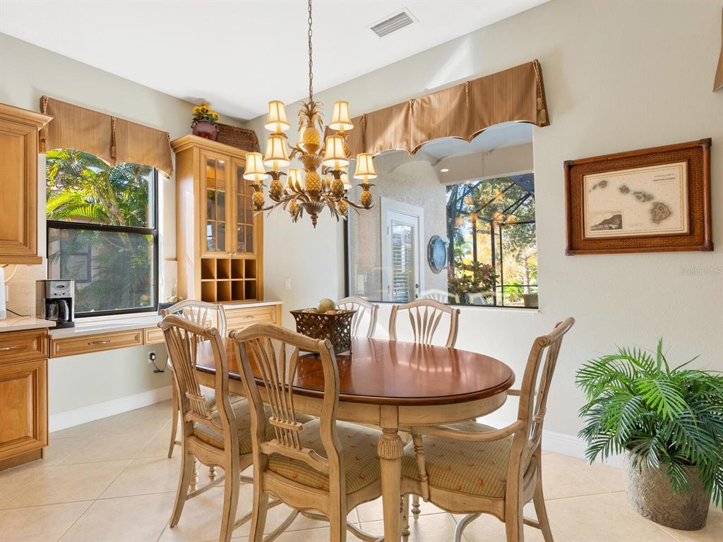 13911 Siena Loop Lakewood Ranch, FL 34202 - Photo 18 of 63 a dining room with furniture a large window and a chandelier