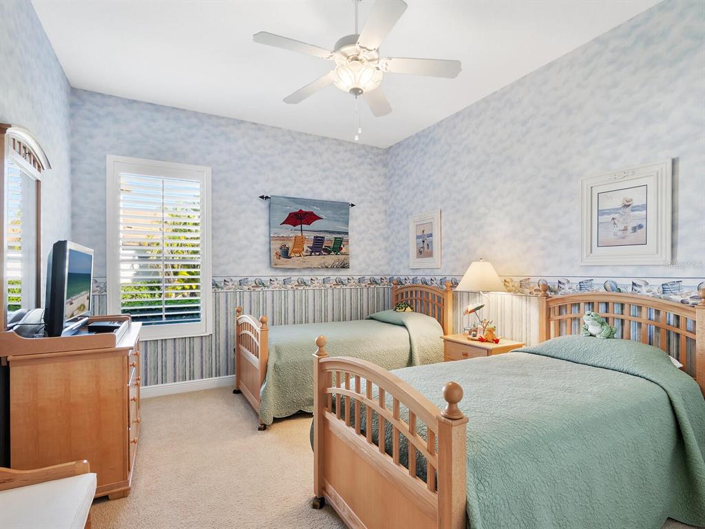 13911 Siena Loop Lakewood Ranch, FL 34202 - Photo 31 of 63 a bedroom with bed and a chandelier