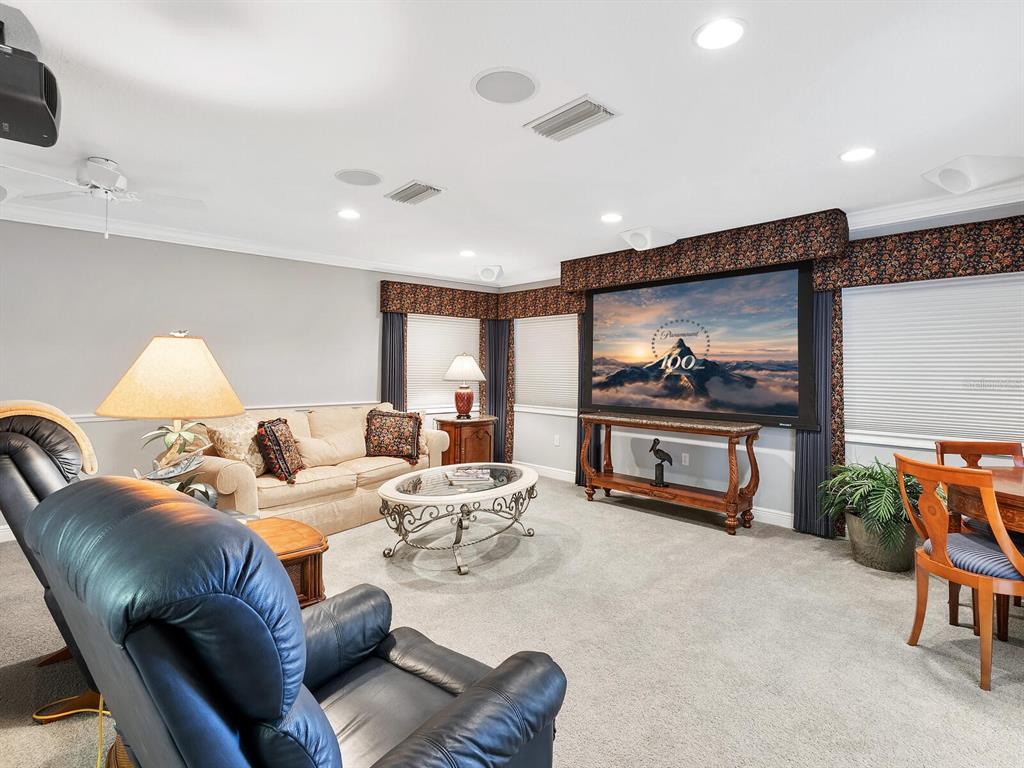 13911 Siena Loop Lakewood Ranch, FL 34202 - Photo 34 of 63 a living room with furniture and a flat screen tv