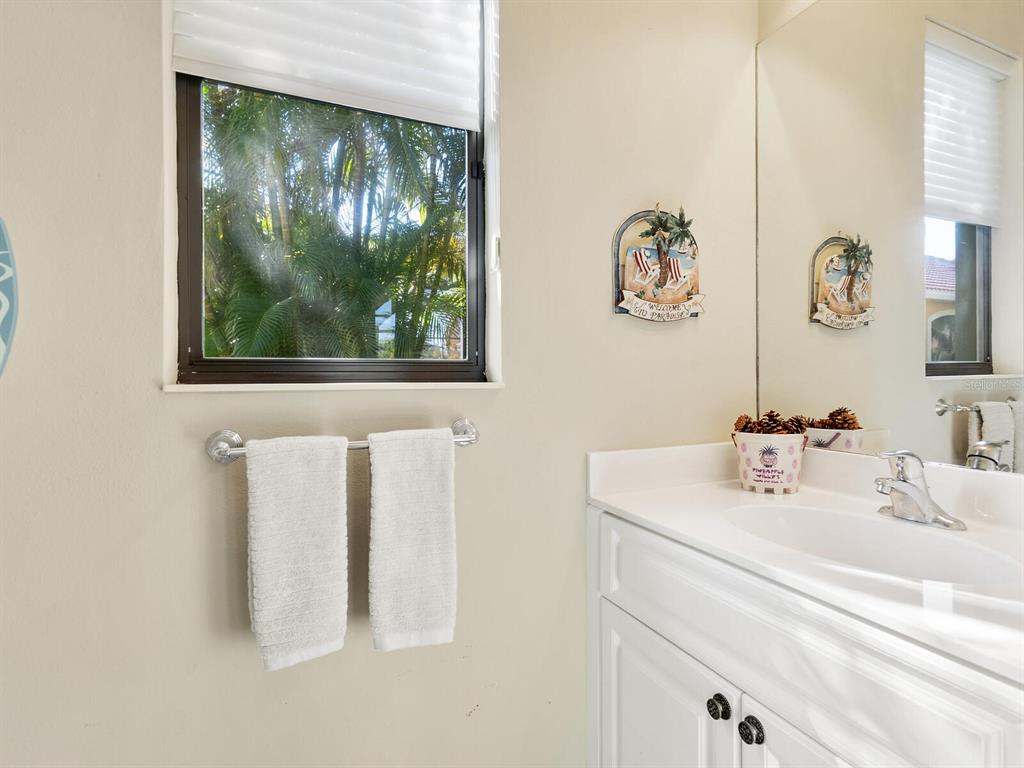 13911 Siena Loop Lakewood Ranch, FL 34202 - Photo 39 of 63 a bathroom with a sink and a mirror