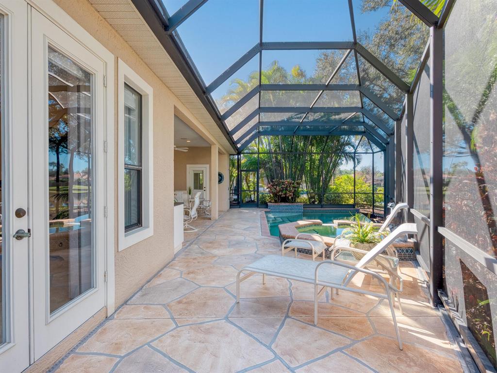 13911 Siena Loop Lakewood Ranch, FL 34202 - Photo 45 of 63 a view of a patio with a table and chairs and a barbeque