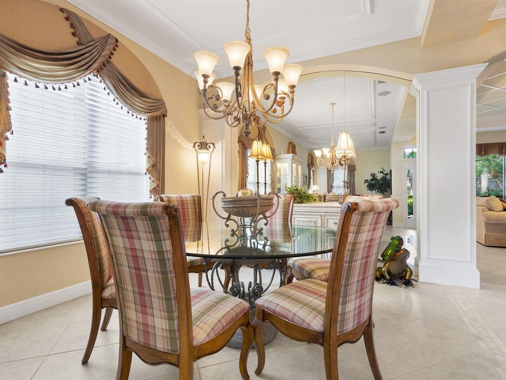13911 Siena Loop Lakewood Ranch, FL 34202 - Photo 10 of 63 a view of a dining room with furniture and a chandelier