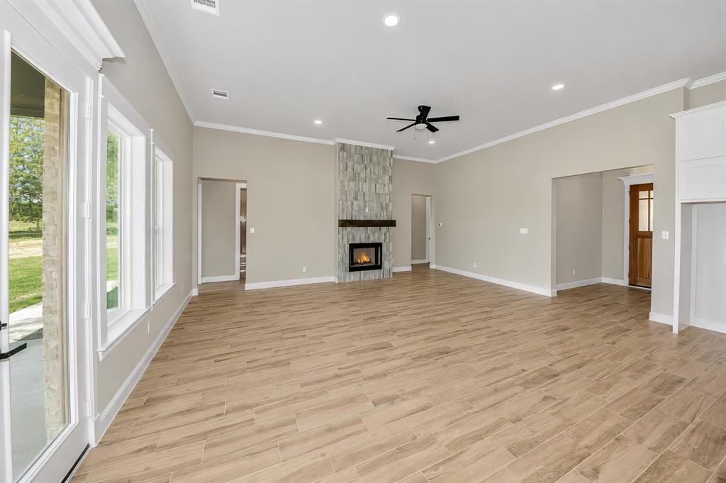 1057 Vh Ranch Poolville, TX 76487 - Photo 9 of 38 a view of a livingroom with a ceiling fan window and wooden floor