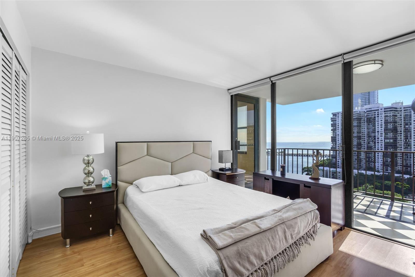 1925 Brickell Avenue, Unit 1811 Miami, FL 33129 - Photo 16 of 63 a bedroom with a bed and a large window