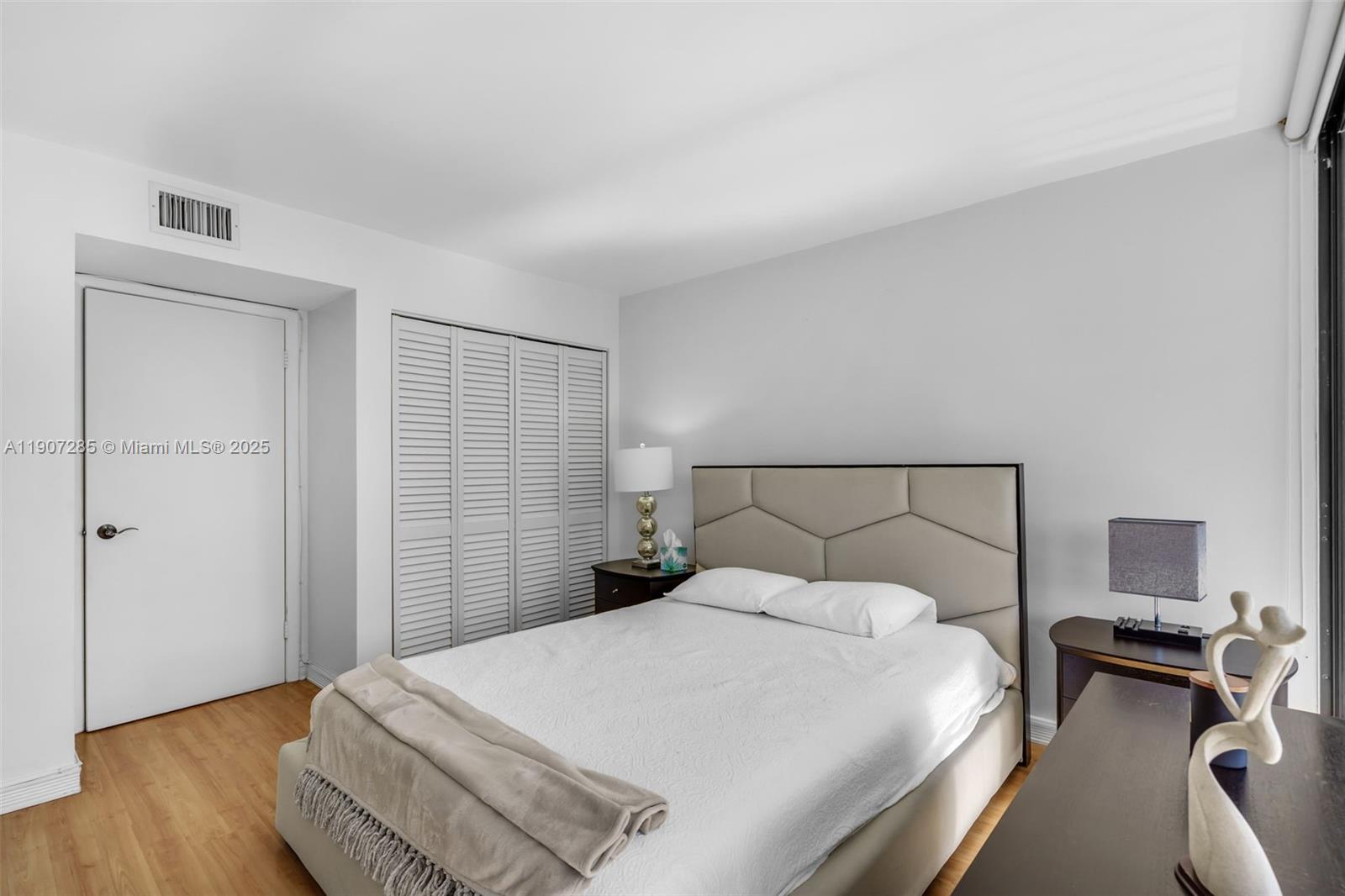 1925 Brickell Avenue, Unit 1811 Miami, FL 33129 - Photo 17 of 63 a bedroom with a bed and wooden floor