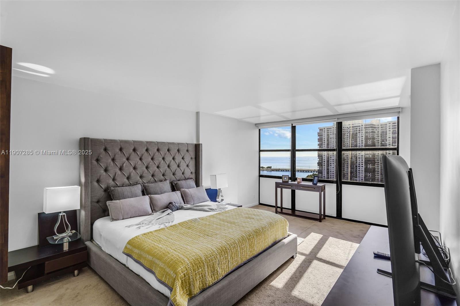 1925 Brickell Avenue, Unit 1811 Miami, FL 33129 - Photo 18 of 63 a bedroom with a bed wooden floor and window