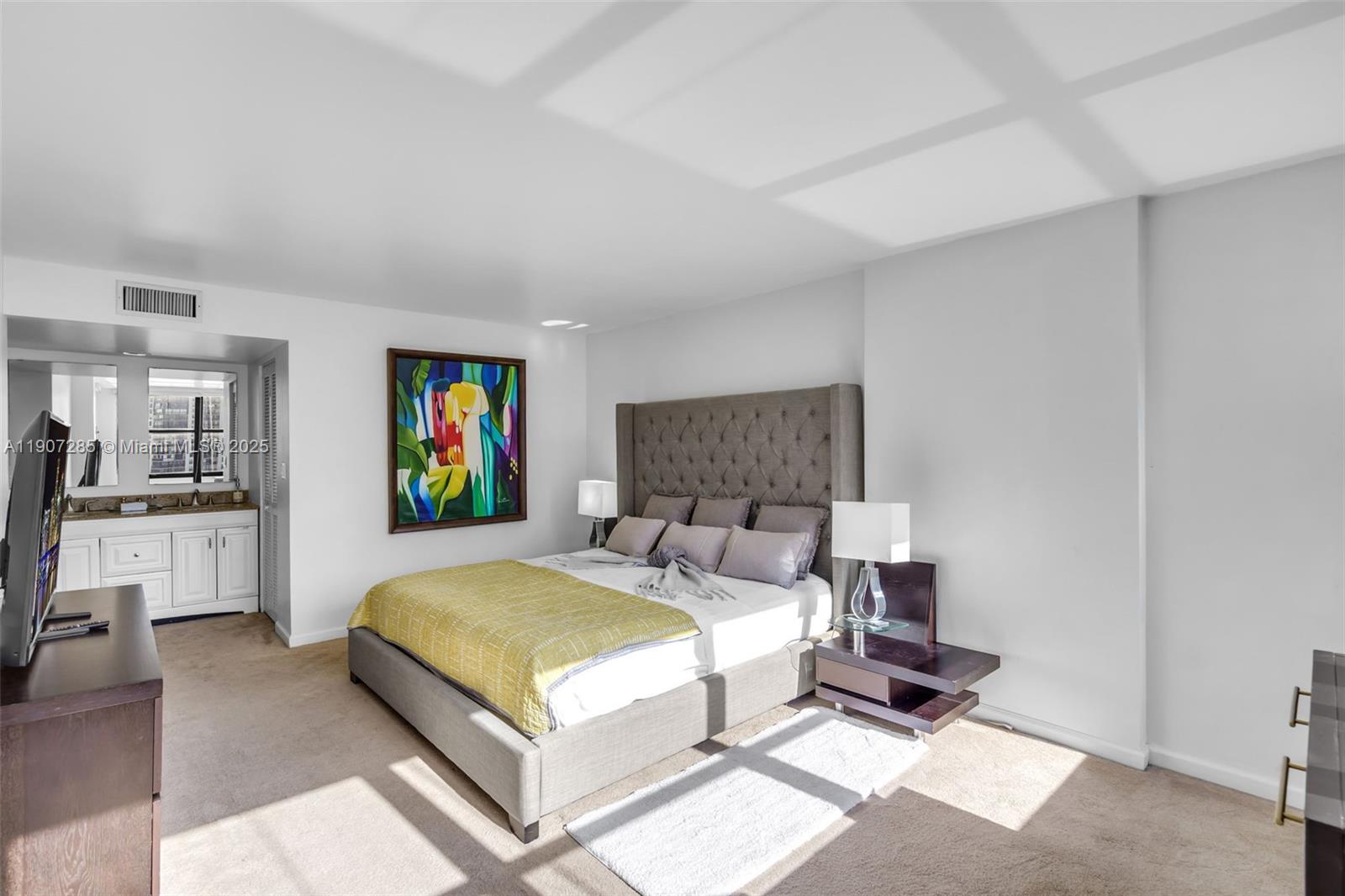 1925 Brickell Avenue, Unit 1811 Miami, FL 33129 - Photo 21 of 63 a bedroom with a bed a mirror and desk