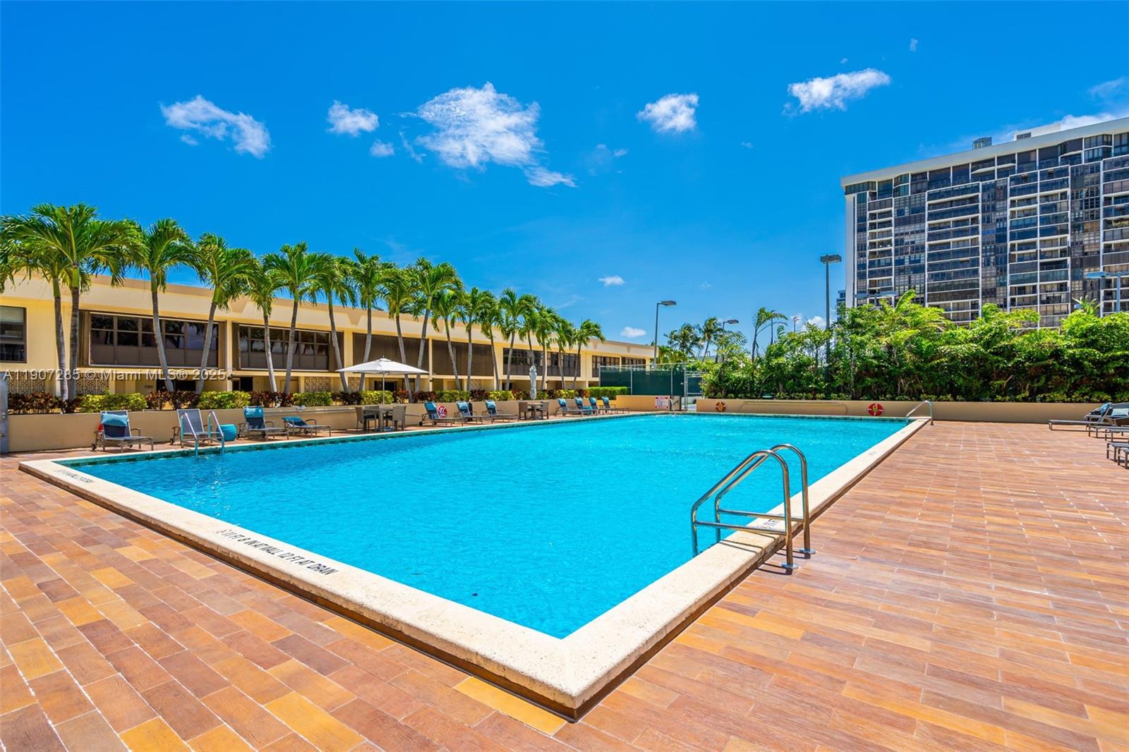 1925 Brickell Avenue, Unit 1811 Miami, FL 33129 - Photo 49 of 63 a view of a swimming pool with a patio and a yard