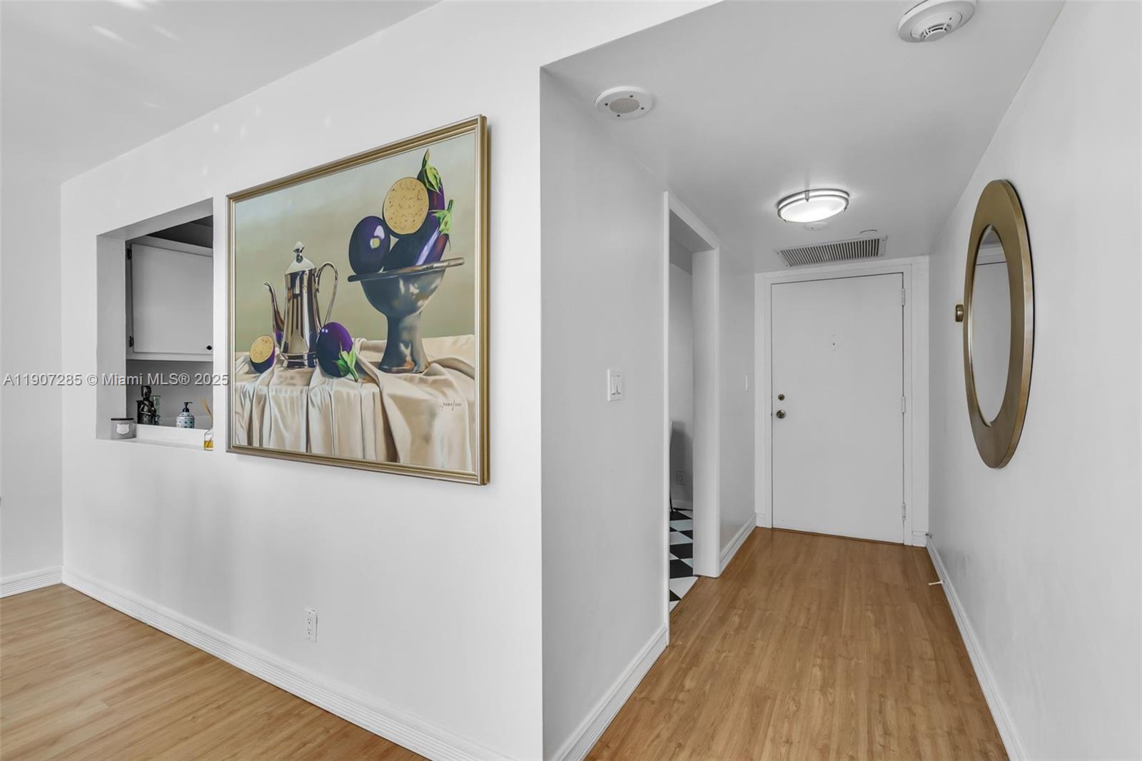 1925 Brickell Avenue, Unit 1811 Miami, FL 33129 - Photo 6 of 63 a view of a hallway with wooden floor and workspace