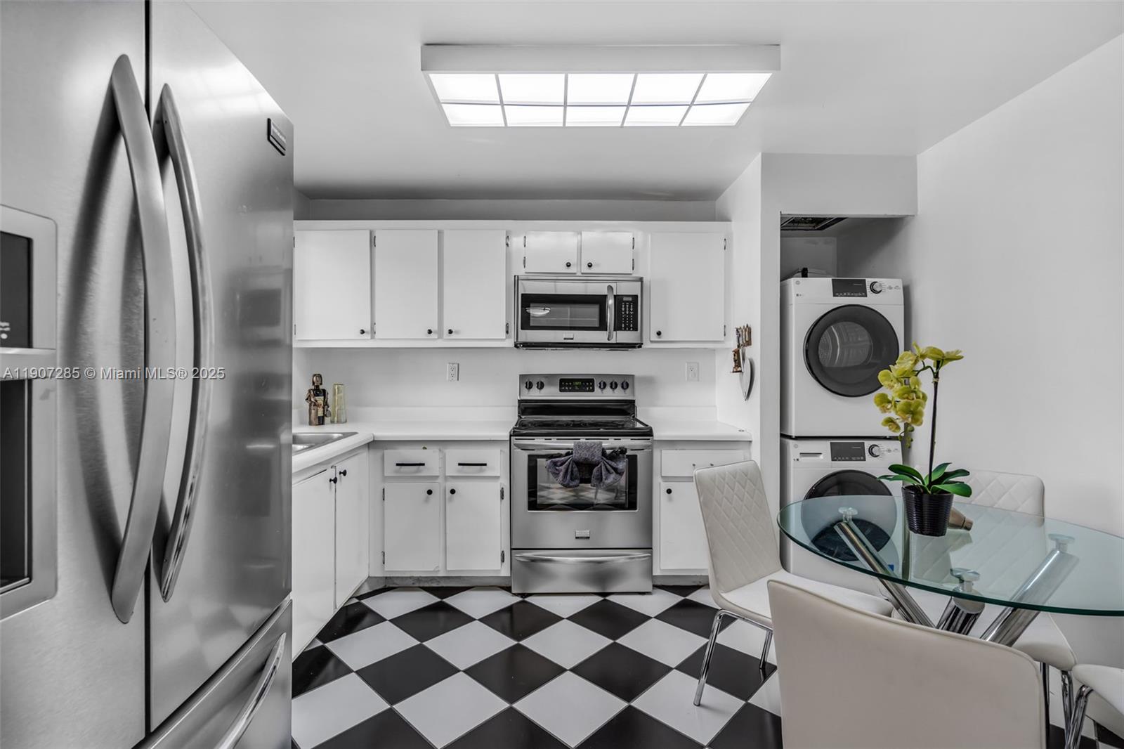 1925 Brickell Avenue, Unit 1811 Miami, FL 33129 - Photo 7 of 63 a kitchen with stainless steel appliances granite countertop a refrigerator oven a sink and a stove