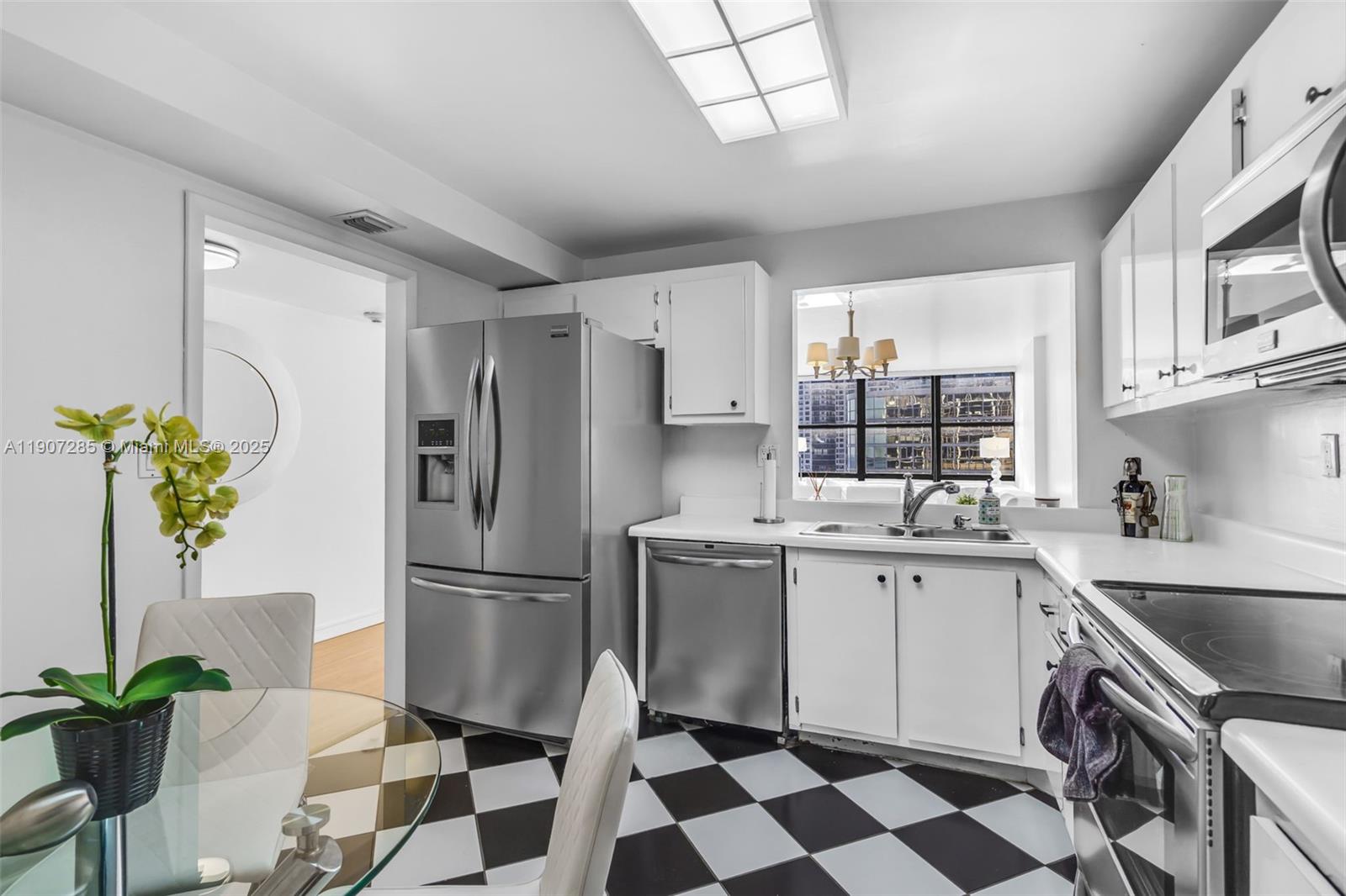 1925 Brickell Avenue, Unit 1811 Miami, FL 33129 - Photo 9 of 63 a kitchen with a stove a sink and a refrigerator