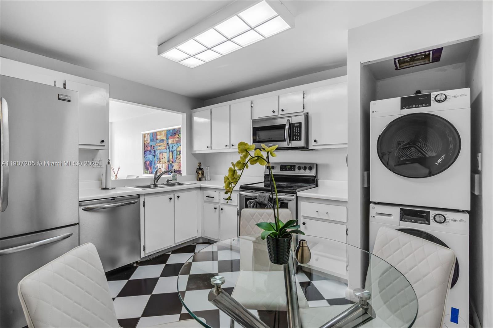 1925 Brickell Avenue, Unit 1811 Miami, FL 33129 - Photo 10 of 63 a kitchen with stainless steel appliances a sink a stove a microwave a refrigerator and cabinets