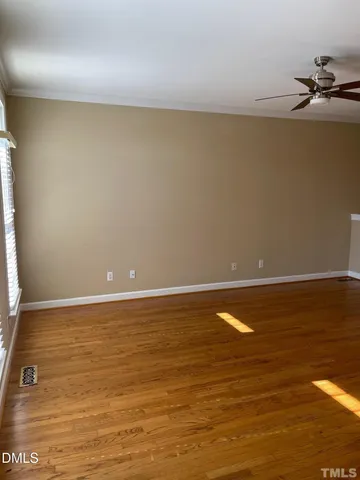 a view of an empty room and wooden floor