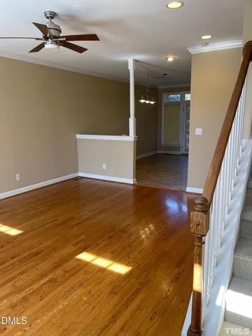 a view of an empty room with wooden floor