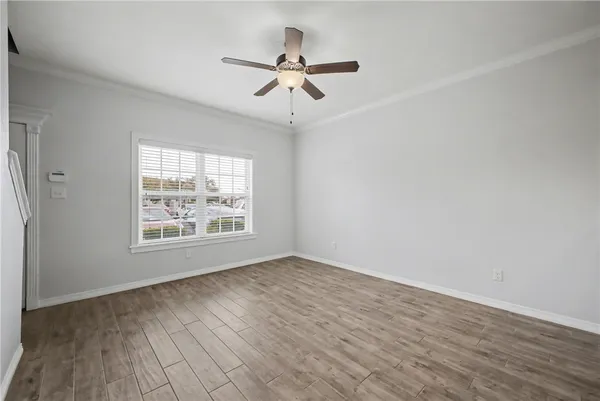 wooden floor in an empty room with a window