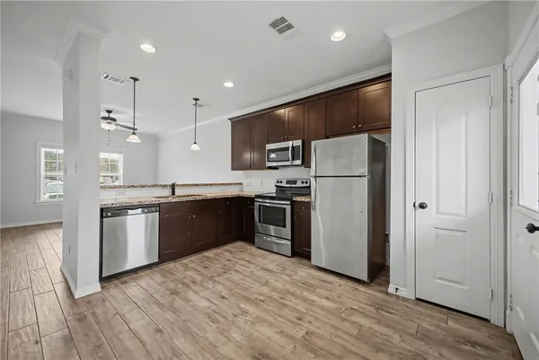 a large kitchen with a refrigerator and a sink