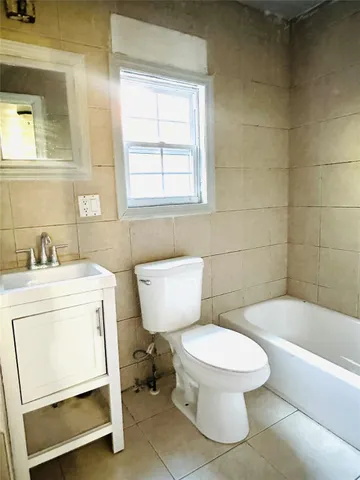 a bathroom with a sink toilet and bathtub
