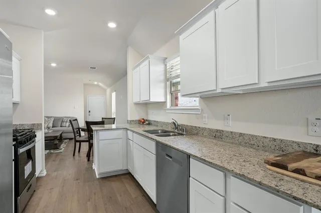 a kitchen with lots of counter top space and stainless steel appliances
