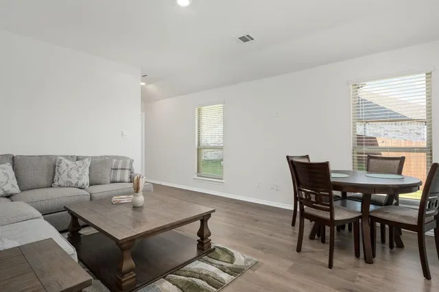 a view of a dining room with furniture and wooden floor