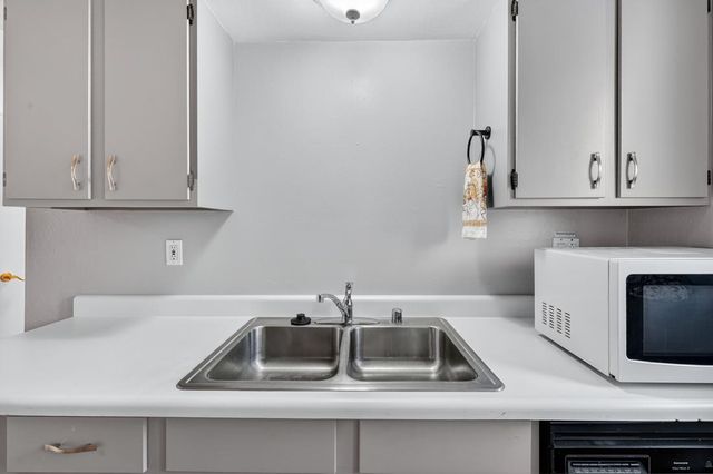 a kitchen with a sink and a microwave