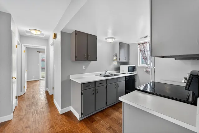 a kitchen with a sink stove and refrigerator