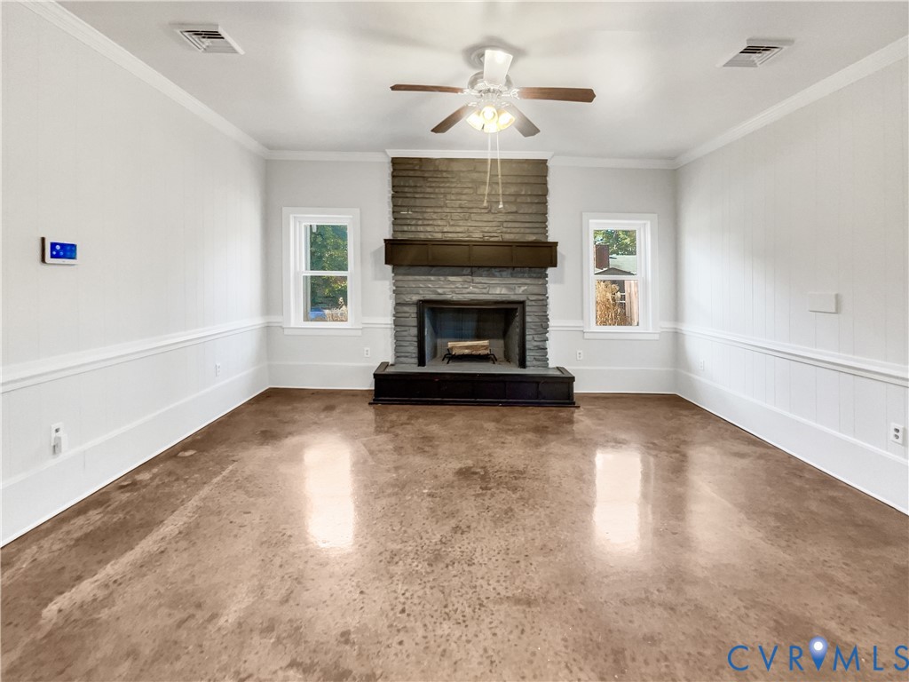 310 Burnwick Road Richmond, VA 23227 - Photo 9 of 21 a view of a livingroom with a fireplace a ceiling fan and windows