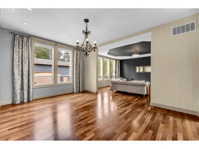 a living room with furniture and large windows
