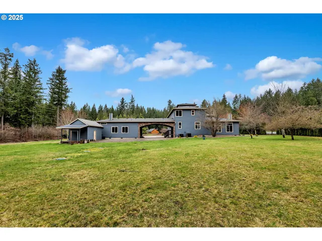 an aerial view of a house with garden space and sitting area