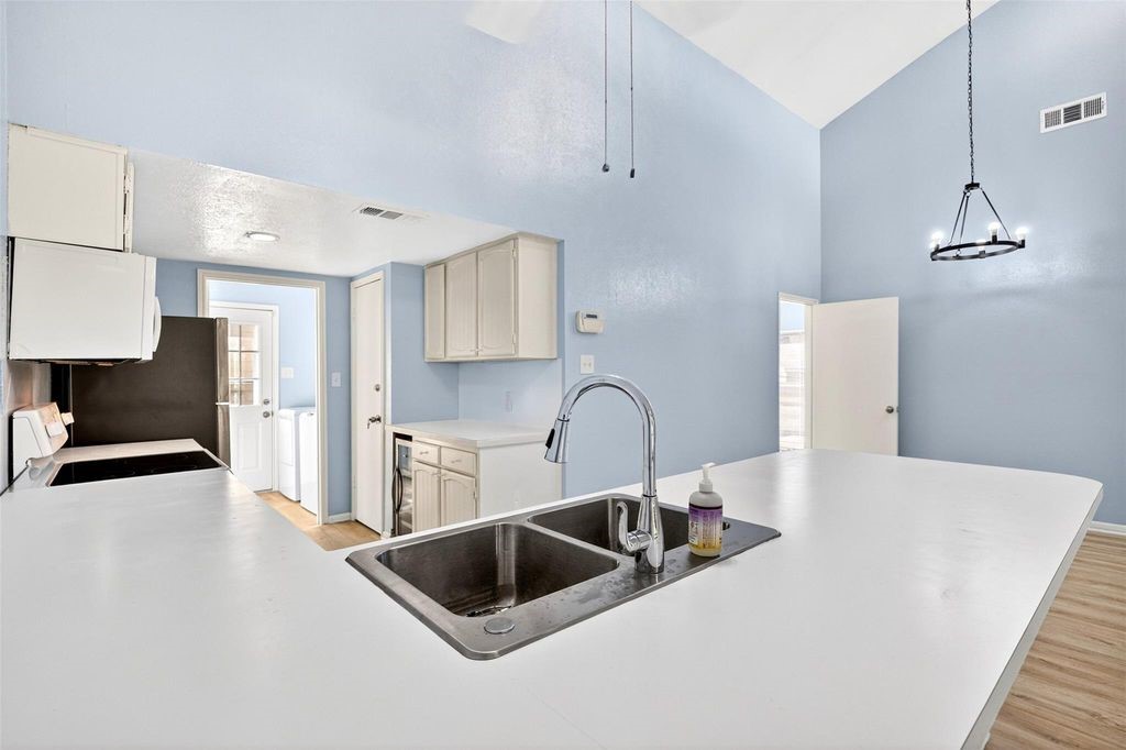 17 April Point Drive North Conroe, TX 77356 - Photo 25 of 42 a kitchen with stainless steel appliances a sink a stove a refrigerator and cabinets