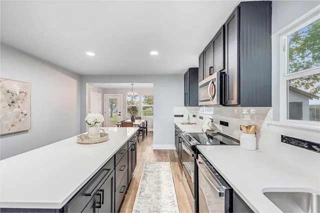 a kitchen that has a sink and a stove