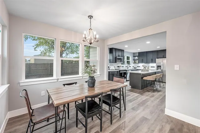 a view of a dining room with furniture wooden floor and chandelier