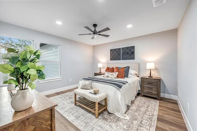 a bedroom with furniture and a potted plant