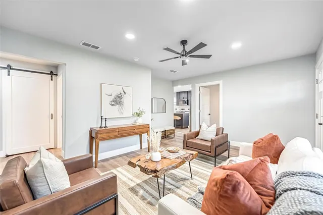 a living room with furniture a rug and a window