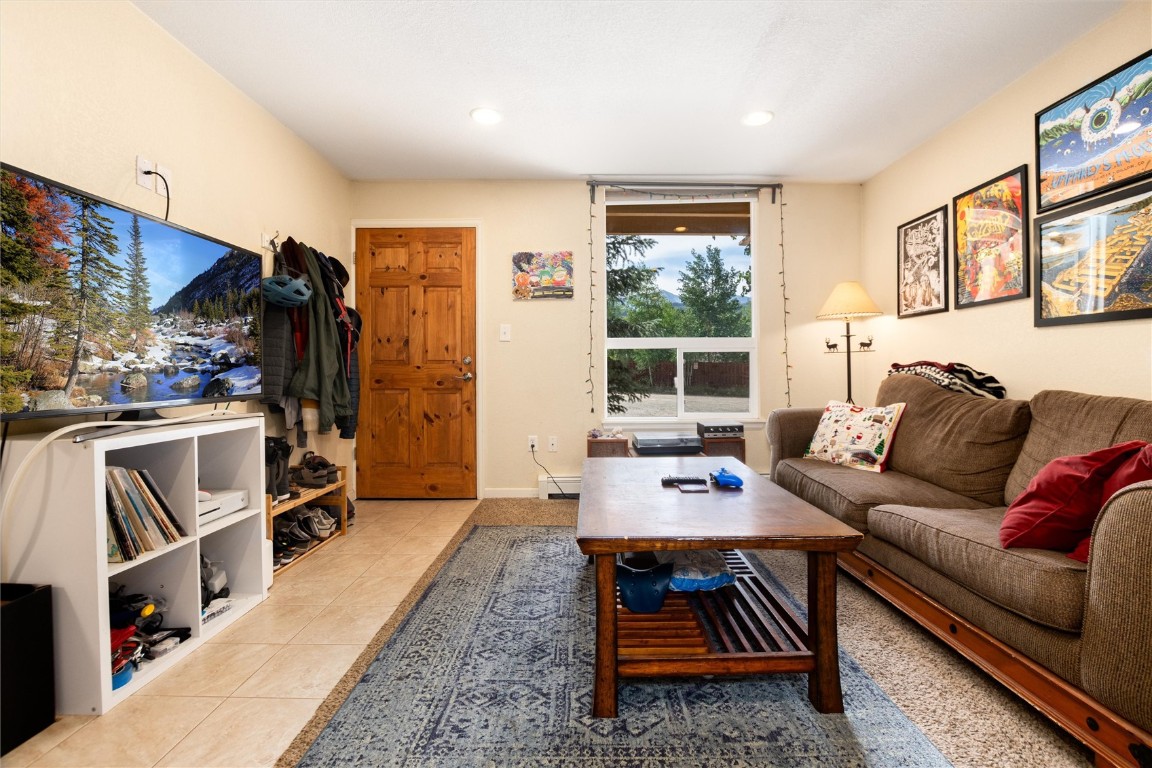 163 High Tor Road, Unit 2 Breckenridge, CO 80424 - Photo 25 of 48 a living room with furniture a rug and a window