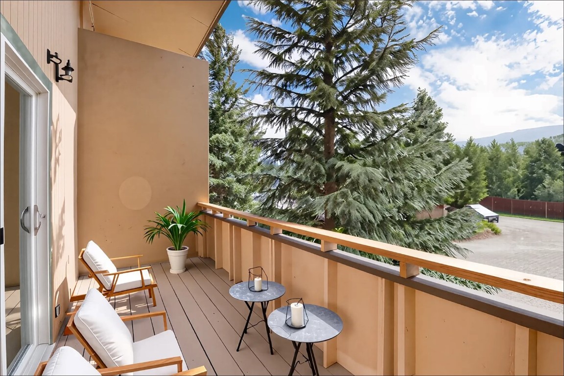 163 High Tor Road, Unit 2 Breckenridge, CO 80424 - Photo 4 of 48 a balcony with wooden floor and some trees