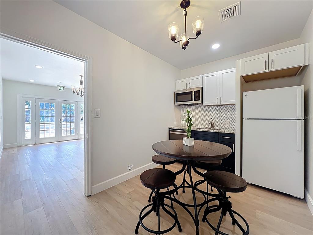 507 East Street Longwood, FL 32750 - Photo 15 of 72 a kitchen with stainless steel appliances a dining table chairs and wooden floor