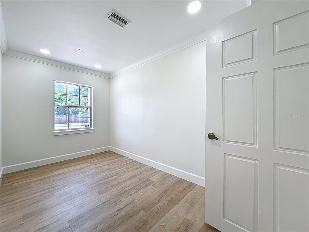 507 East Street Longwood, FL 32750 - Photo 24 of 72 an empty room with wooden floor and windows