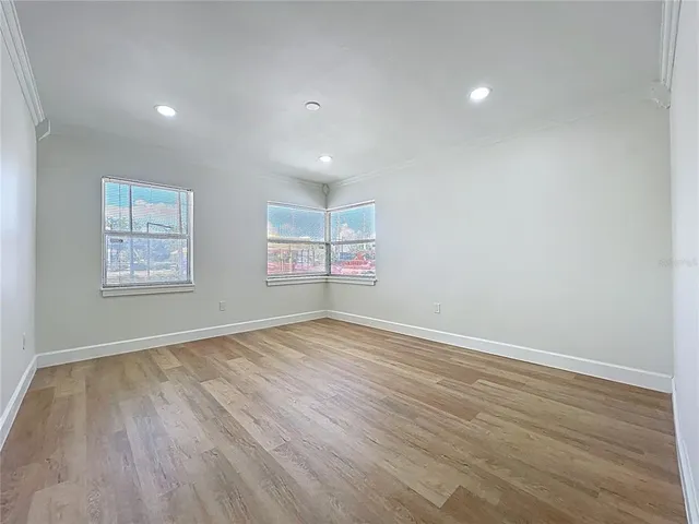 a bathroom with granite countertop a sink and wooden floor