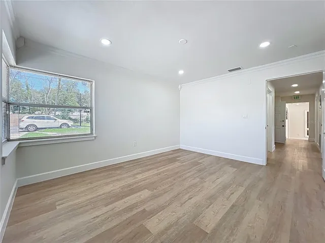 wooden floor in an empty room with a window