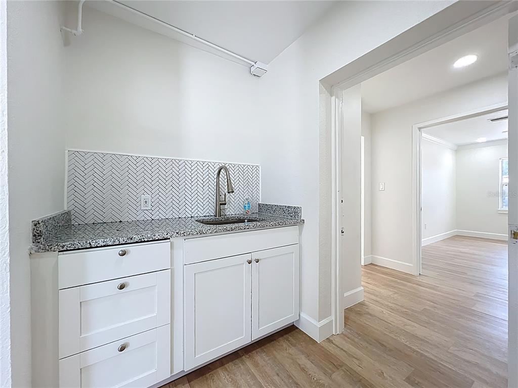 507 East Street Longwood, FL 32750 - Photo 39 of 72 a bathroom with granite countertop a sink and wooden floor