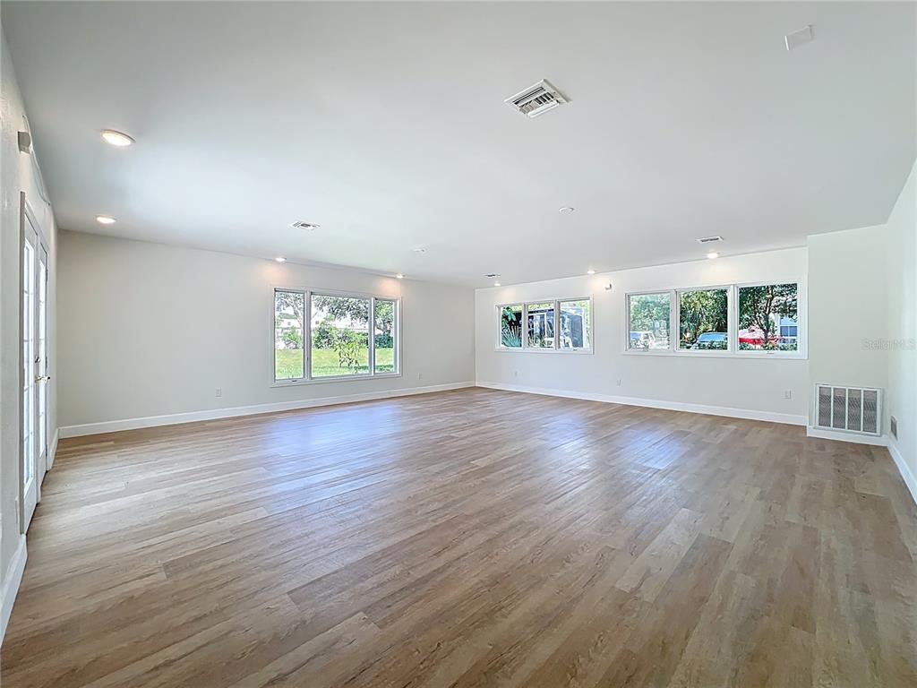 507 East Street Longwood, FL 32750 - Photo 47 of 72 an empty room with wooden floor and windows