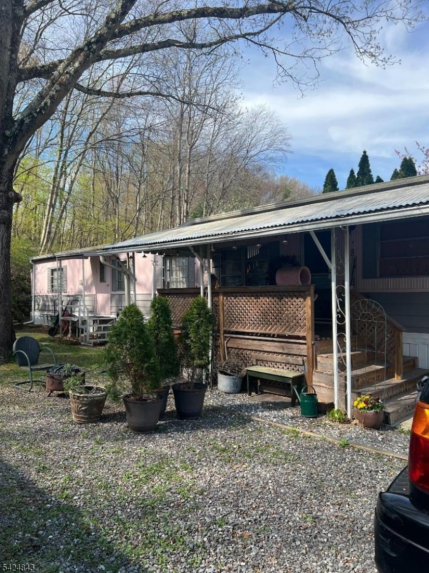 a view of a house with a yard and furniture