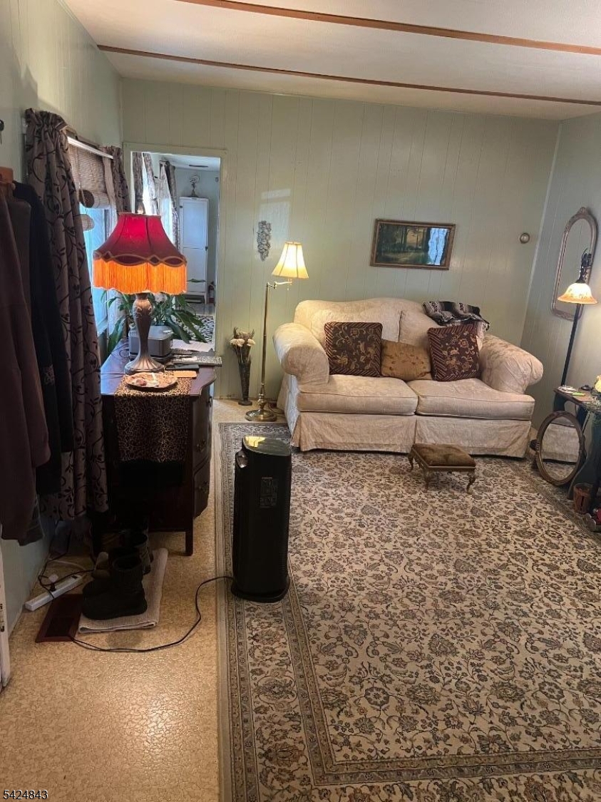 55 Back Street Oxford, NJ 07863 - Photo 5 of 16 a living room with furniture a flat screen tv and a fireplace