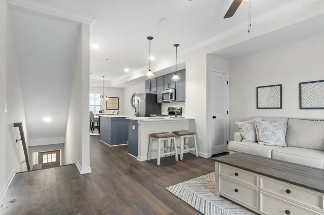 a living room with furniture and kitchen view
