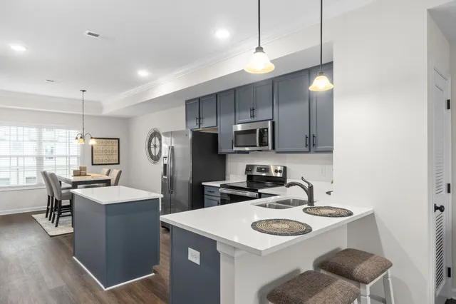 a kitchen with stainless steel appliances a sink stove and refrigerator