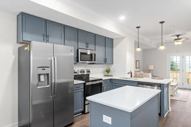 a kitchen with stainless steel appliances a refrigerator sink and microwave