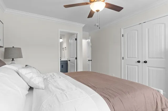 a bedroom with a large bed and a chandelier